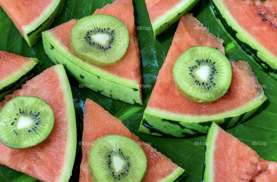 Red watermelon slices with green kiwis 