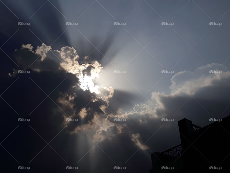 sun coming out of clouds