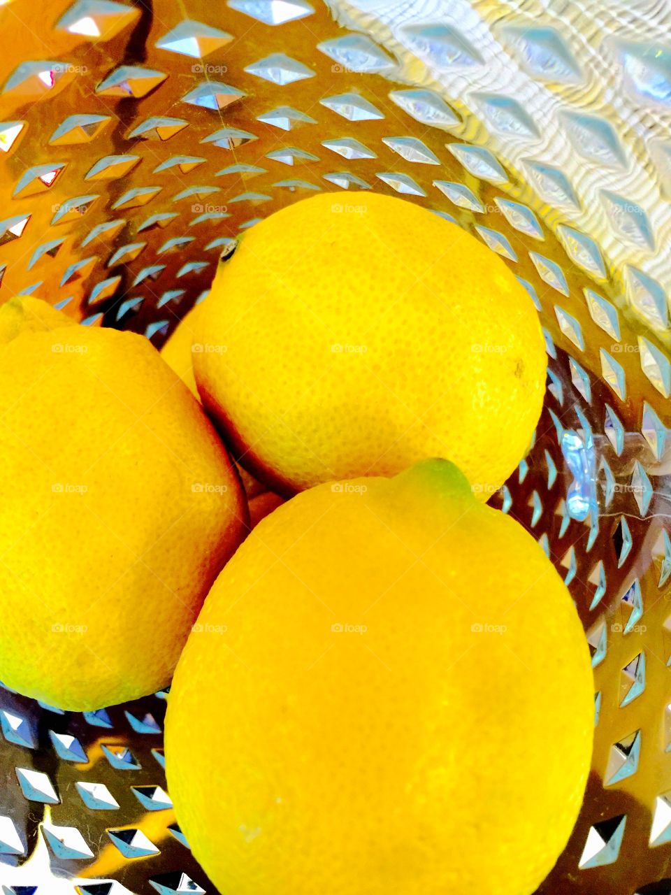 Citrus Pileup . Lemons placed in a clear plastic pitcher.