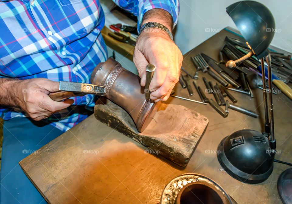 Coppersmith making dezva with old tools