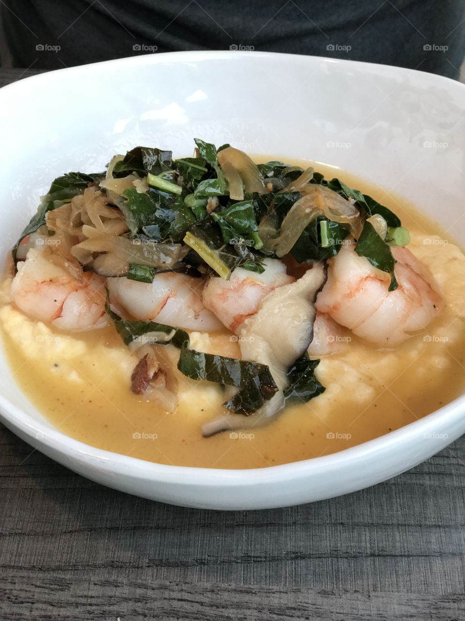 Jumbo Shrimp and grits served with fresh greens.