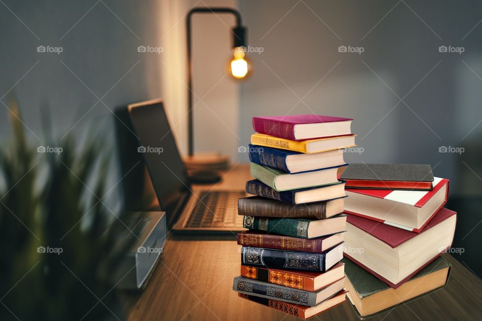 desk with laptop and books