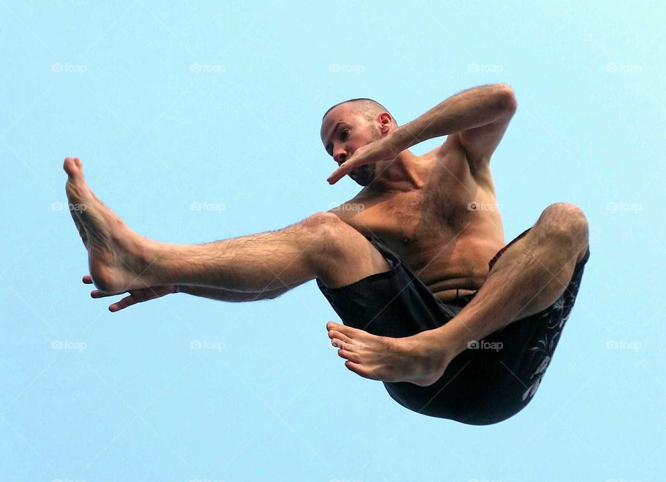 Low angle view of a karate man jumping