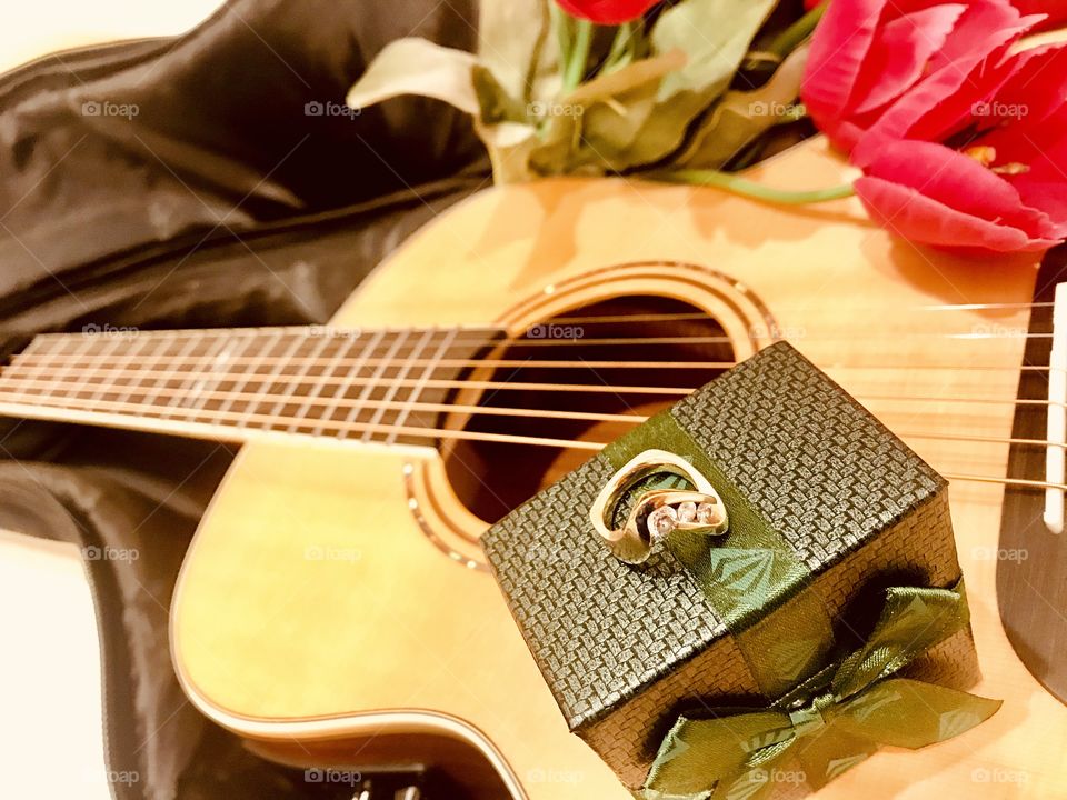 Fun photo of guitar with guitar case filled with books, money, and camera for trip! 