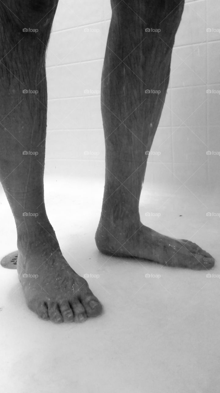 Man's feet in the shower