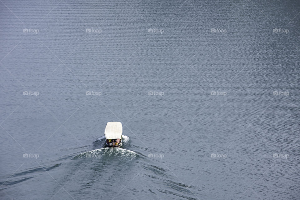 The tourist boat on water at Khun Dan Prakan Chon Dam ,Nakhon Nayok in Thailand