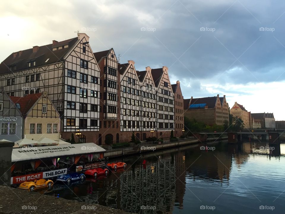 Buildings on the river bank of a canal in Gdansk with boats