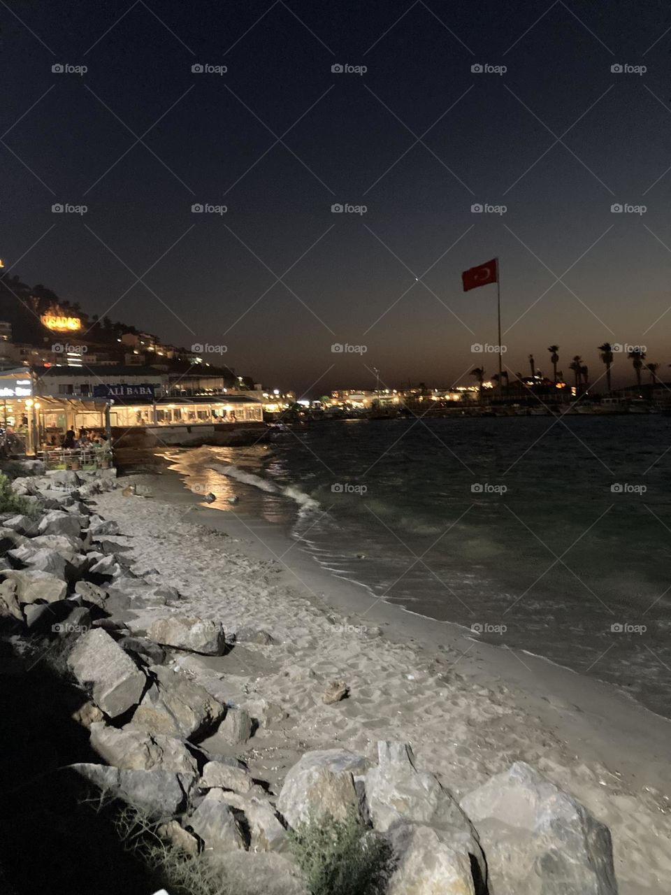 Beach time on holidays. Blue sky and tall palm trees. Sunsets and sunny days. Summertime in Kusadasi. Vacation travel in Turkey . Summer view. Sunny day during vacation 