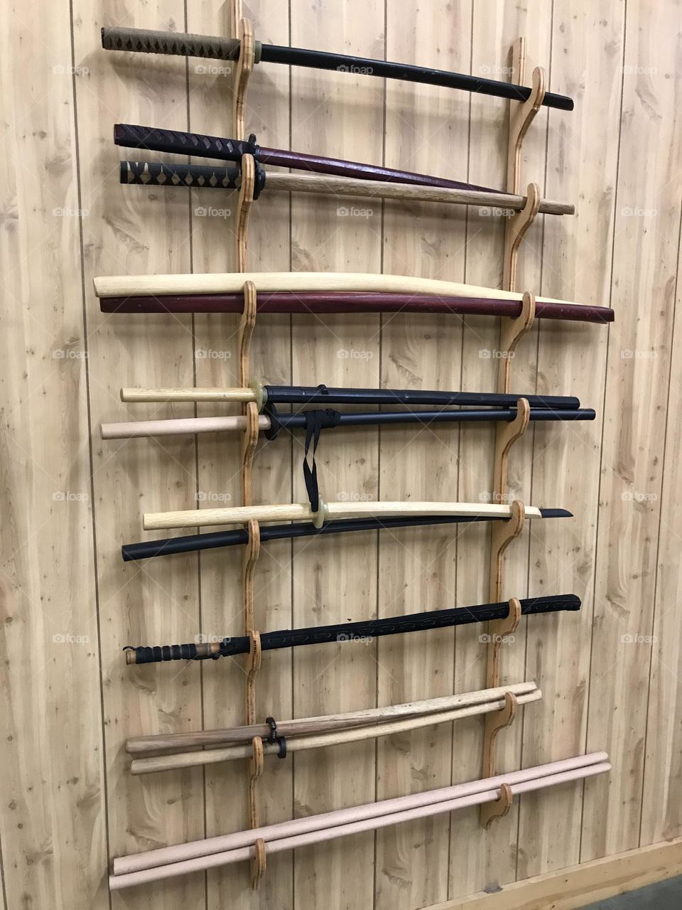 A weapon rack in the Japanese martial arts dojo. Any of these training weapons is utilized to improve and maintain my personal health and fitness.