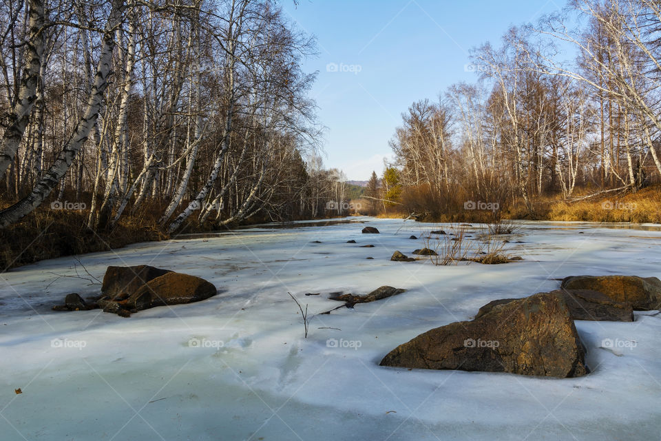 Landscape with a frozen river
