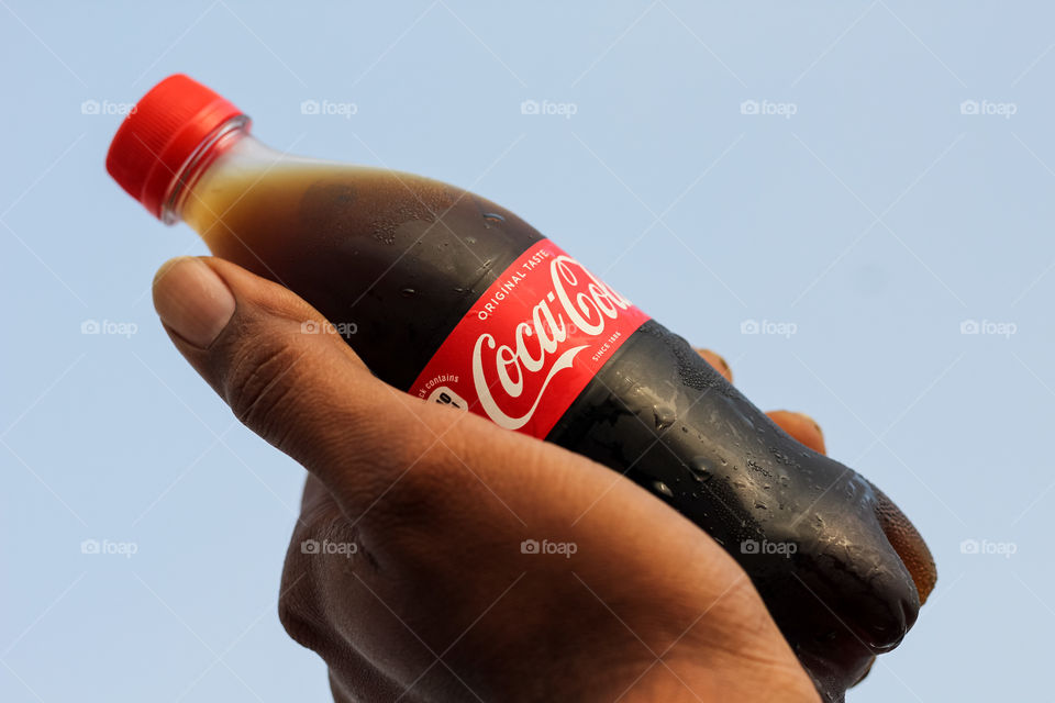 Holding the coca-cola pet bottle