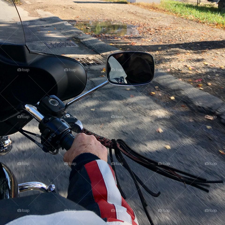 View of our Harley ride from the back seat π! Fringe flying in the wind & my hubby's strong arm taking control as we go down the road with our leathers on!ππ