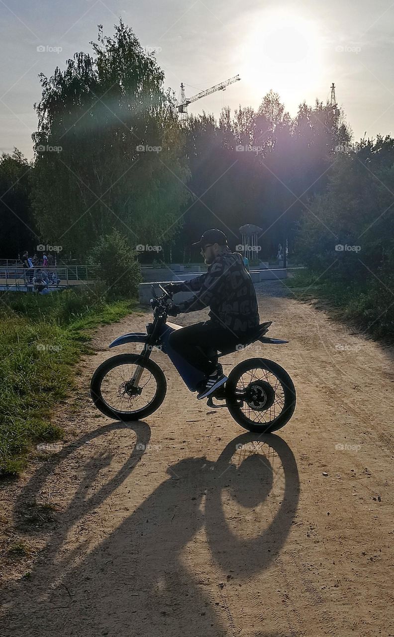 men on a electric motorcycle, summer time