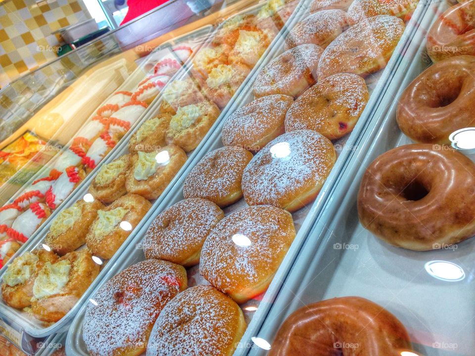 Donut shop. Donuts on shelves at Krispy Kreme 