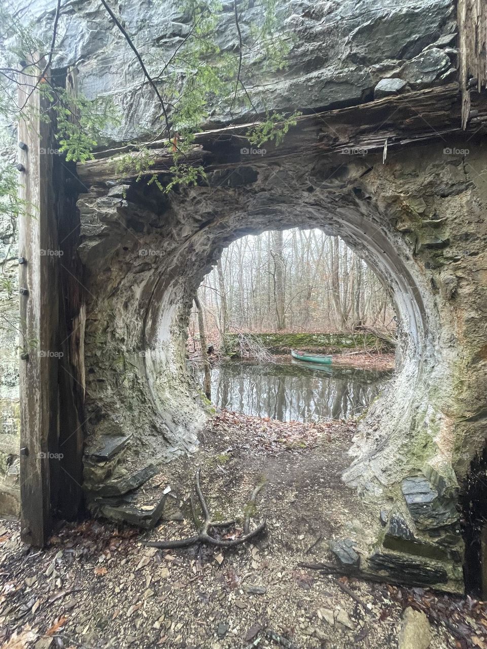 Canoe viewed through stone arch