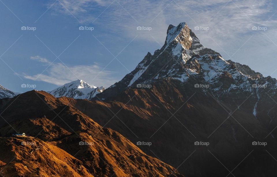 A scenic panorama sunrise view of Machapuchare mountain In Himalayas 