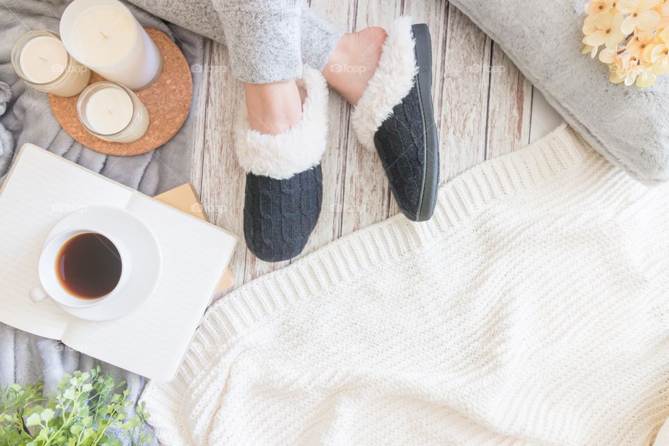 Cozy flatlay with female in slippers