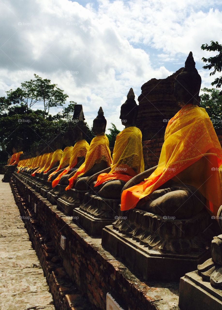 Buddha statues in yellow . Buddhist temple in Bangkok 