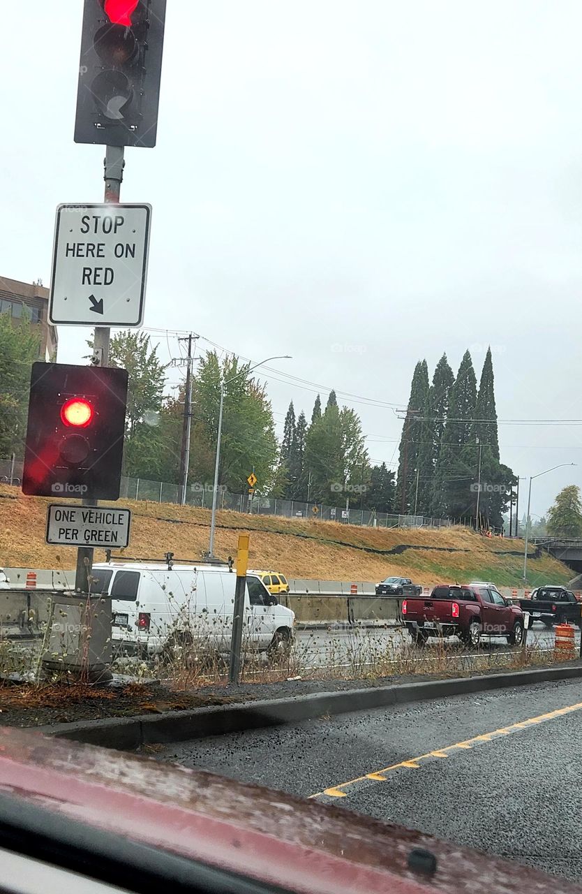 stop on red sign post and light help to direct early morning commuter traffic on a gray week day in Oregon