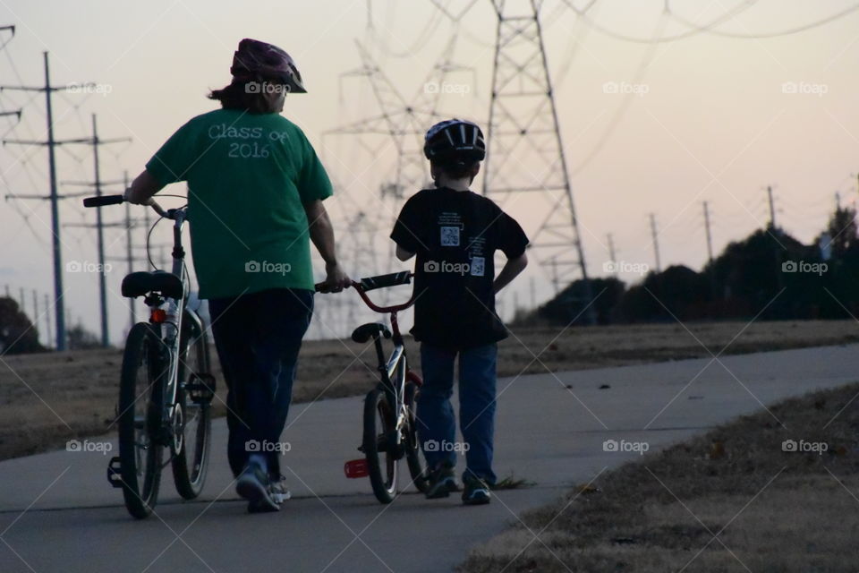 Mother and son. Evening ride
