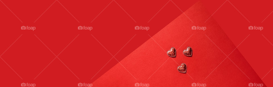 Red hearts on a red background. Valentine's Day.