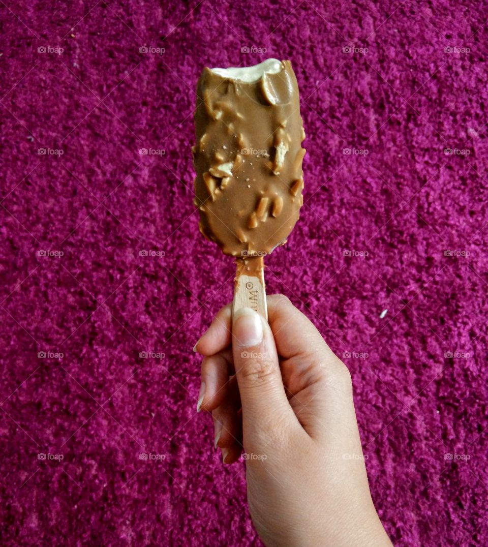 pink fancy background. hand holding icecream