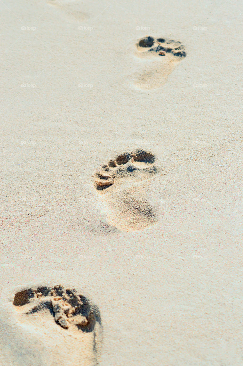 Fußabdrücke im Sand am Strand von Mexiko.