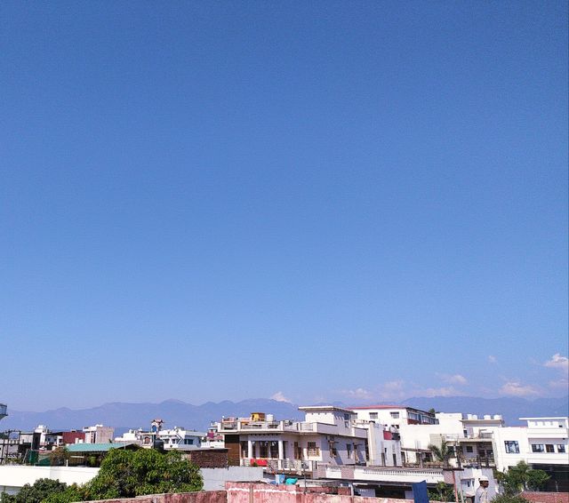 The beautiful Mussoorie hills and an exquisite blue sky providing a wonderful backdrop to the town of Dehradun, the City of Love