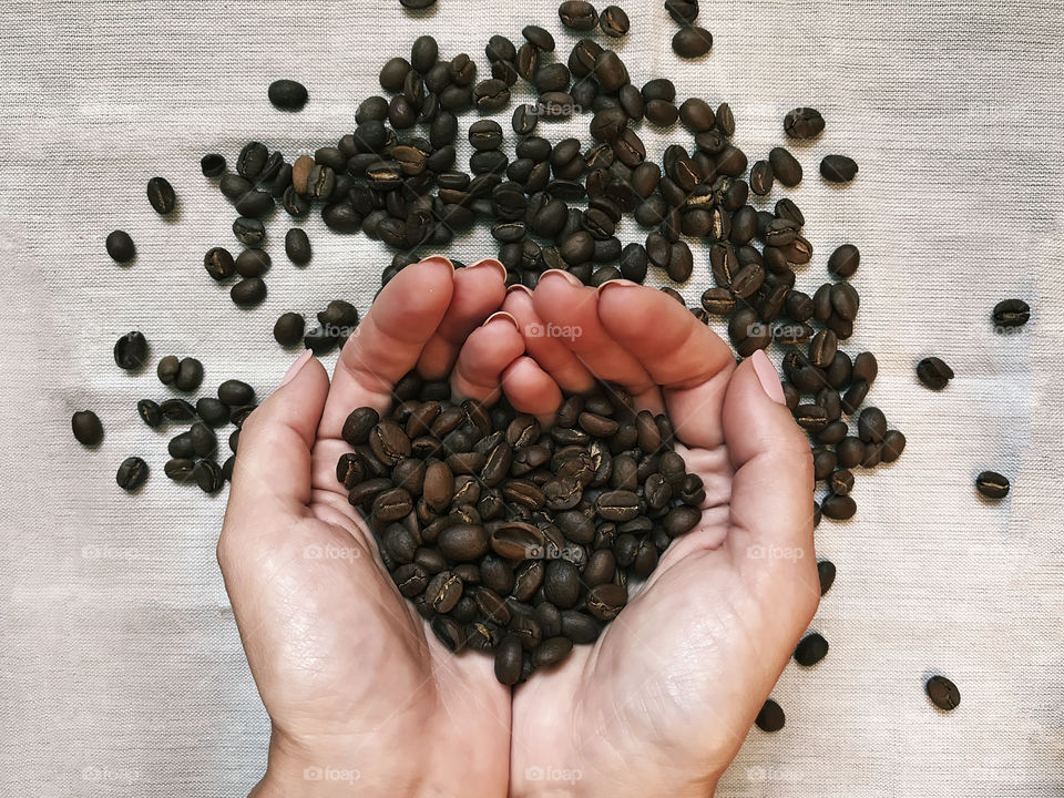 Coffee beans in hands 