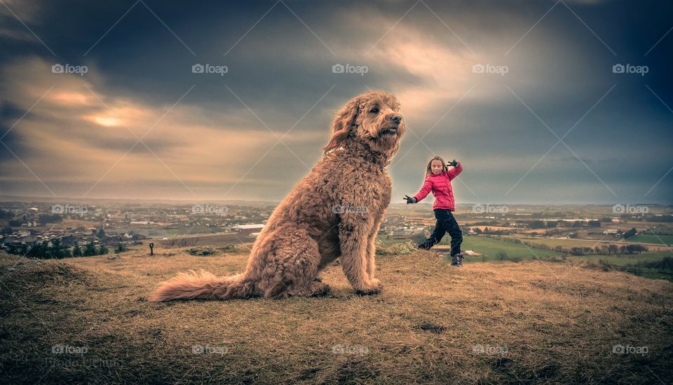 Girl with dog at hill