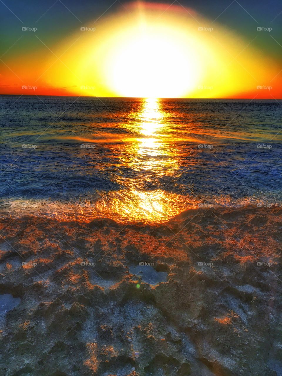 Sun reflecting on sea at sunset