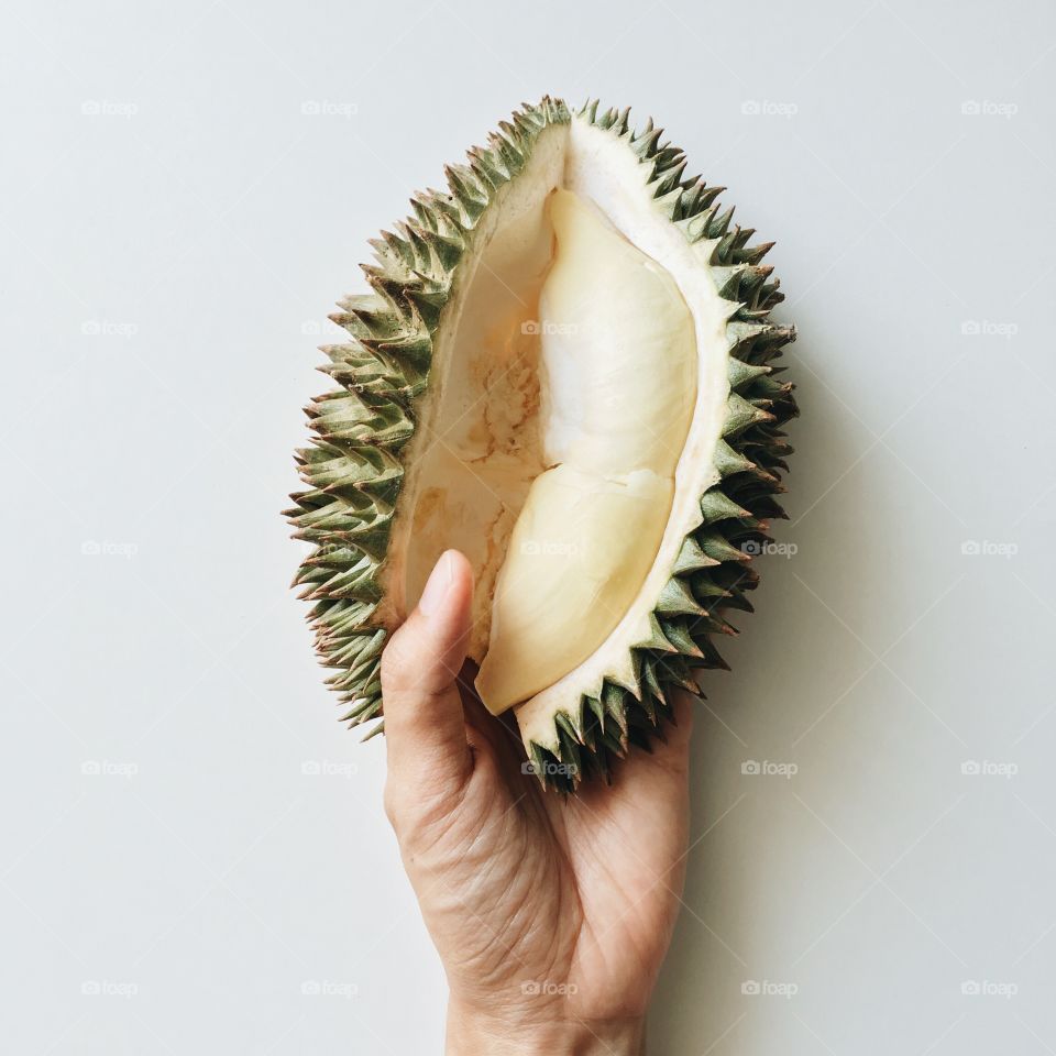 Person holding durian fruit