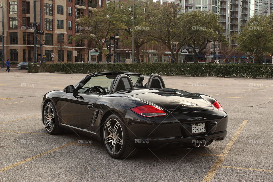 Black 2010 porsche boxster s 987.2 in city with apartments