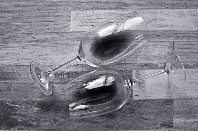 Glasses of wine on wooden table.