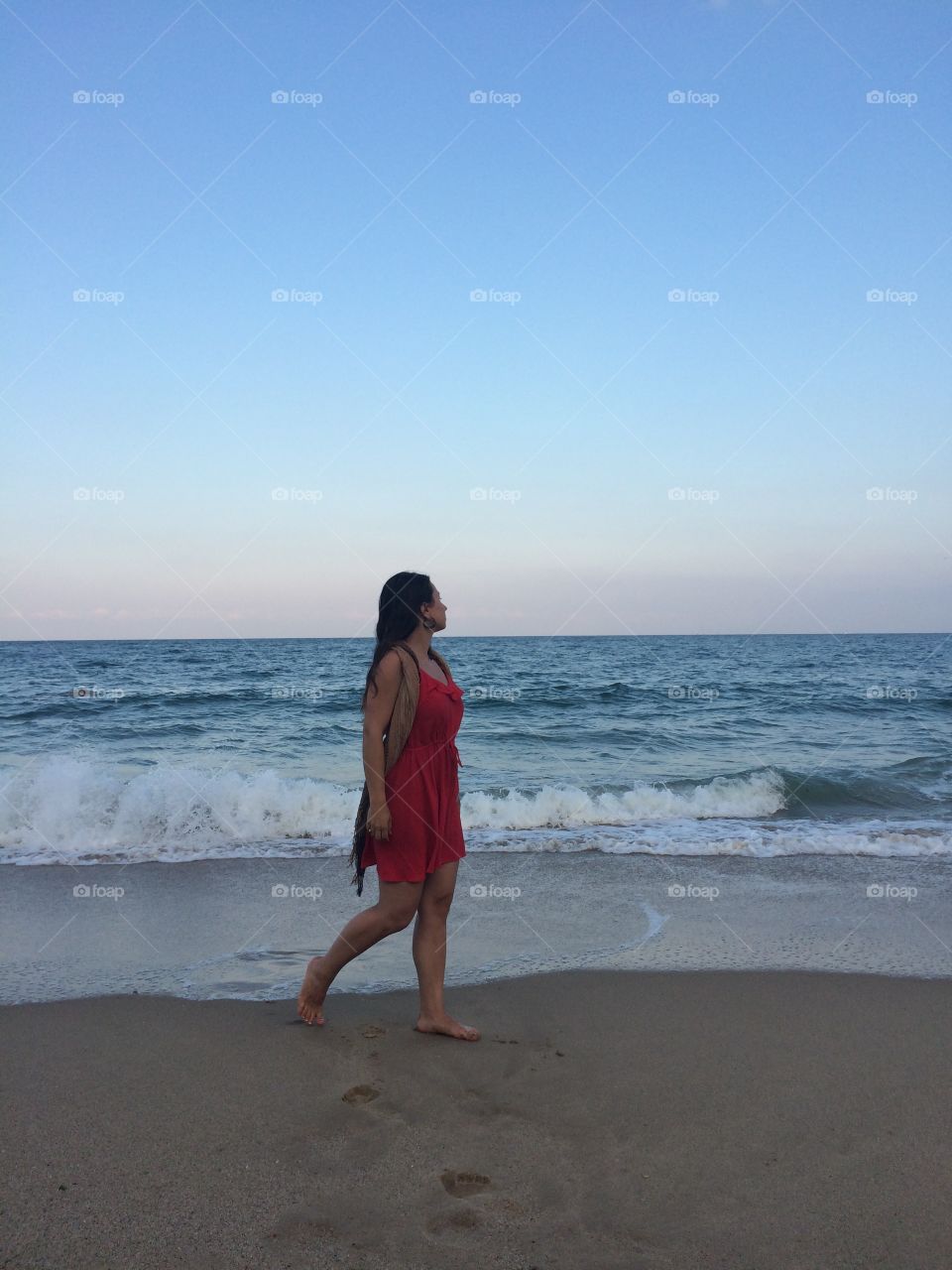 Girl strolling along the beach