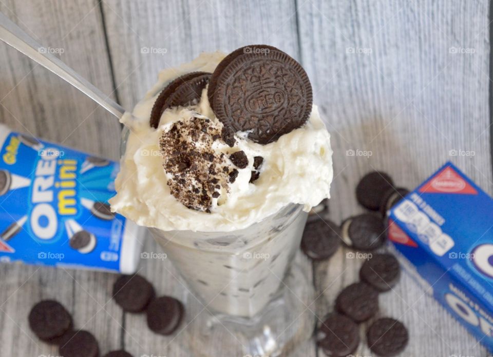 Oreo cookie milkshake with a wooden rustic white background