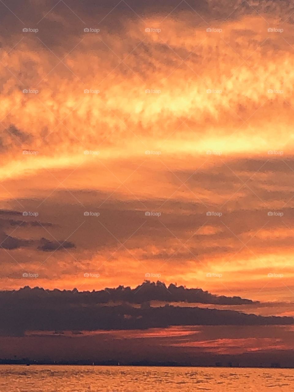 Beautiful clouds colored by the red sunlight trying to burst through the clouds. 