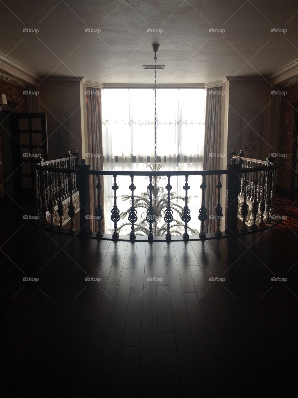 A ceiling lamp from the second floor view agains a window