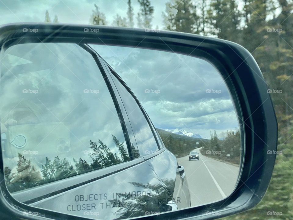 Scenic view through the car mirror 