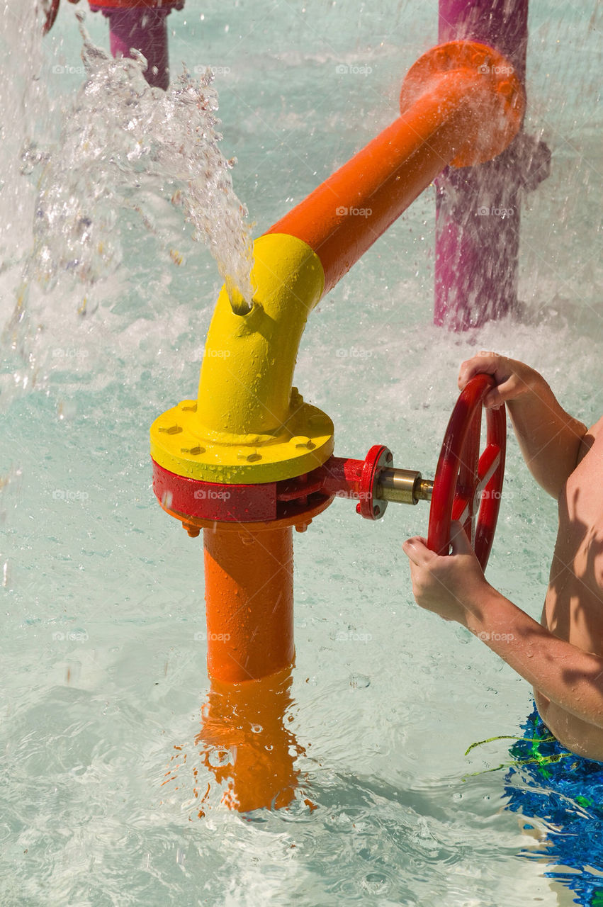 Boy playing in water park, Florida