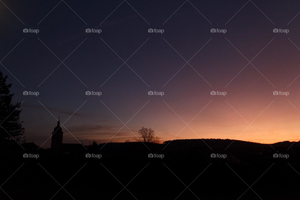 Sunset over a small town in Germany with a beautiful gradient in the sky.