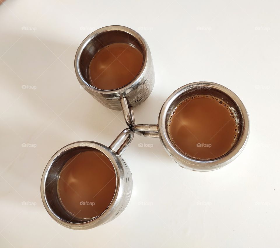 Three cups of tea: indian milk tea, brown tea