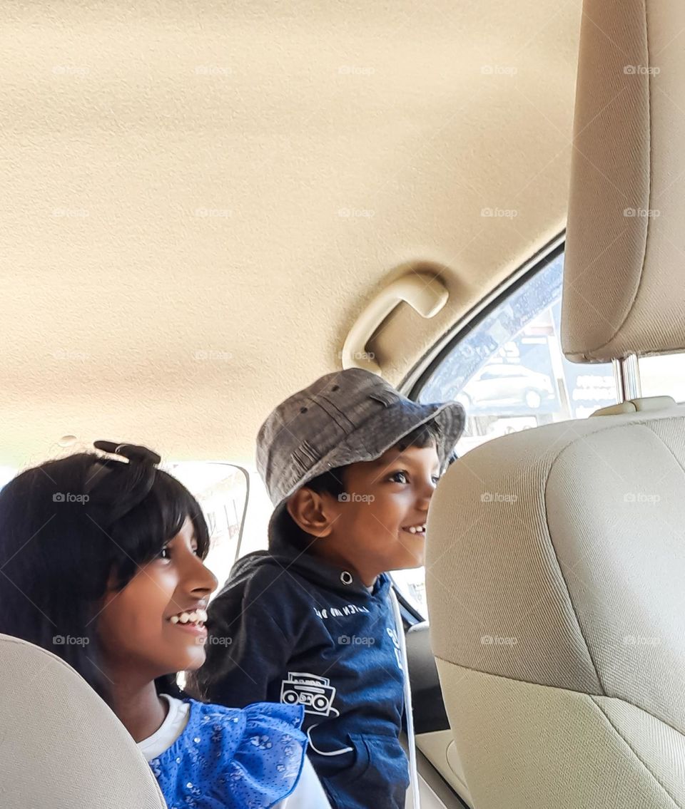 Kids looking through the car window