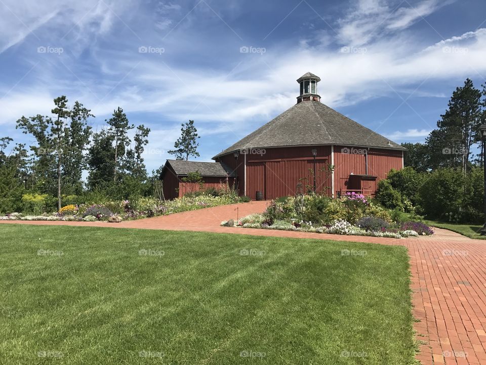 Octagon Shaped Historic Structure at Old World Wisconsin - Red Clausing Barn and Gardens - Green Grass Lawn and Beautiful Blue Sky 