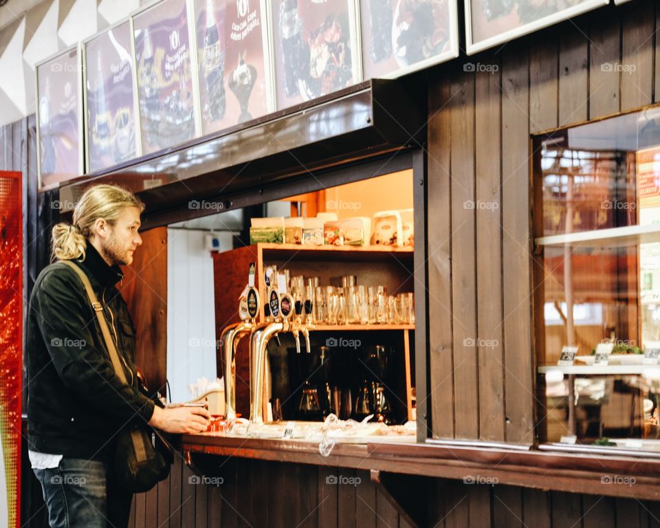 Man standing on café counter