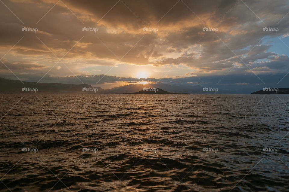 Sunrise after rainy night over Adriatic Sea. Croatian mainland in the background with a Split town. Europe.