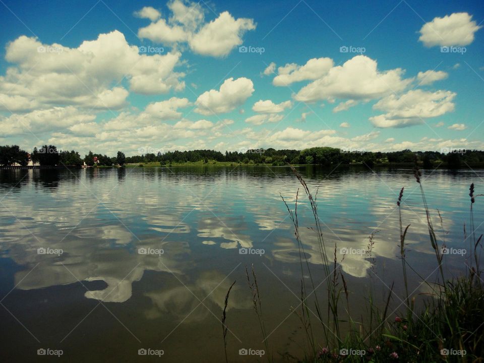 Reflection of clouds on idyllic lake