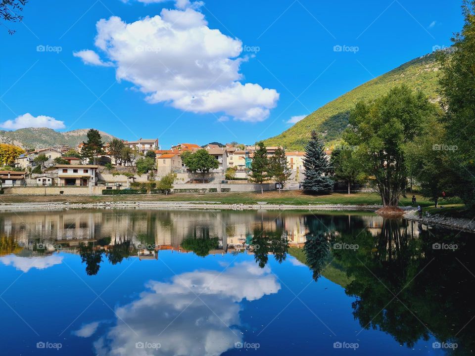 The village of Villa Lago in Abruzzo is reflected on the lake