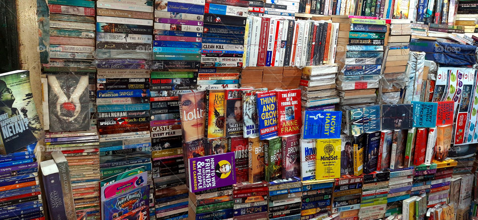 Routine & habits of daily life,Reading good  books.Modern retail bookseller shop with many educational and fiction literature,best seller novels on the shelves.