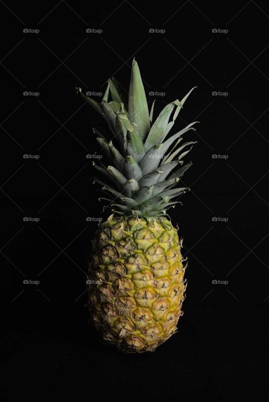 Natural pineapple on black background